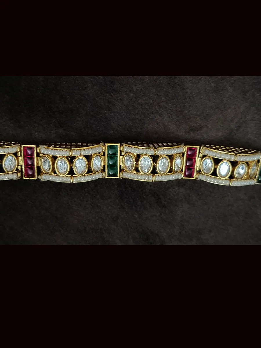 Single flexible openable kundan bracelet with cheed pirohi on sides and ruby green stones detailing