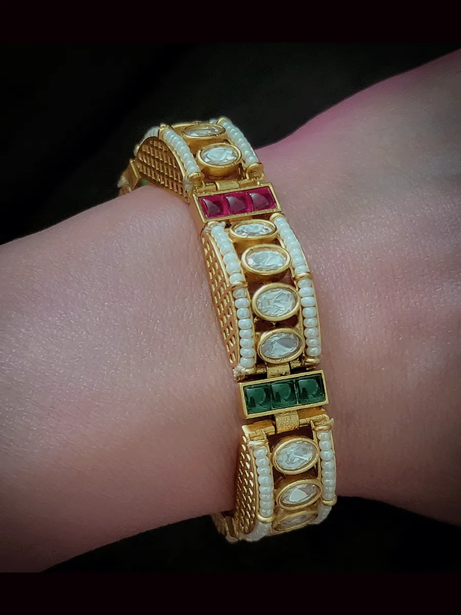 Single flexible openable kundan bracelet with cheed pirohi on sides and ruby green stones detailing